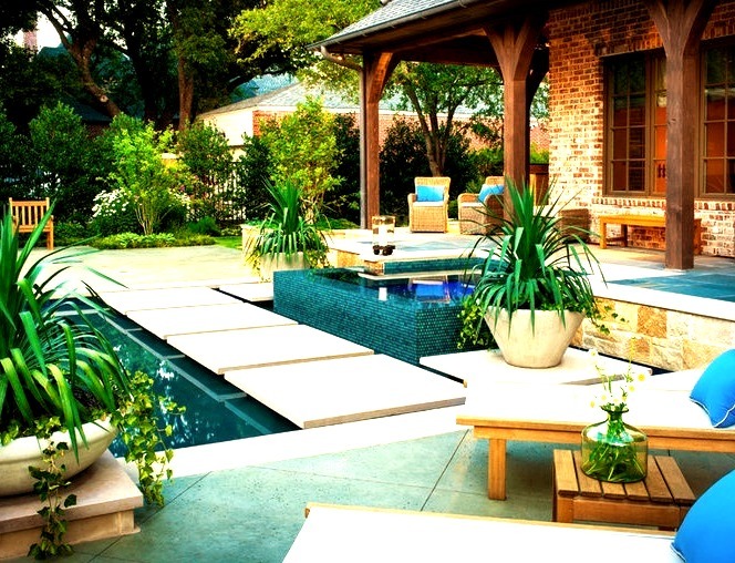 Inspiration for a large modern backyard stone and custom-shaped hot tub remodel